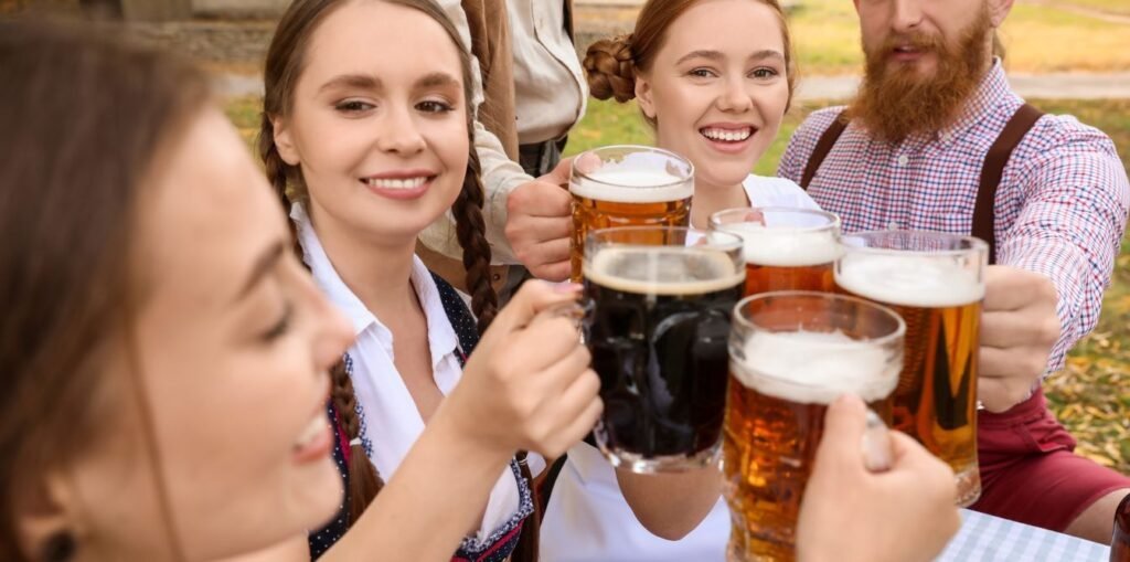 octoberfest people sitting on table enjoying showcase beer glass